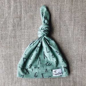 Copper Pearl top knot hat in poe print